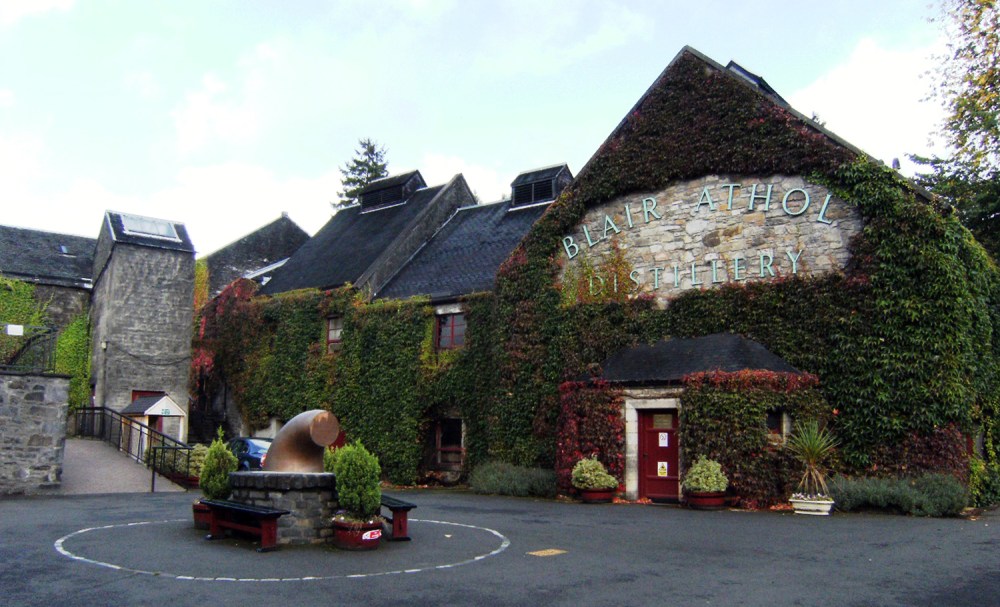 Ivy-covered distillery building with a circular courtyard feature.