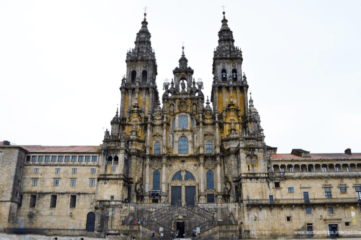 Front view of a large, ornate cathedral with twin towers and intricate stonework.